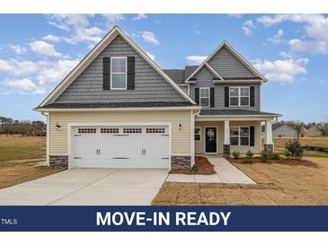 Charming two-story home with a two-car garage and a mix of siding and stone accents at 54 Barony Ln, Smithfield, NC 27577