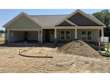New construction home featuring a light green exterior, gray roof, and an open garage at 56 Bailey-Boykin Rd, Selma, NC 27576