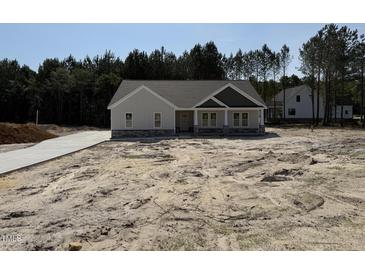 Charming single-story home with a combination of siding and stone accents, plus a new driveway at 612 Tuscany Cir, Princeton, NC 27569