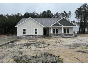 Charming new construction home with stone accents, covered entry, and professionally landscaped yard at 612 Tuscany Cir, Princeton, NC 27569