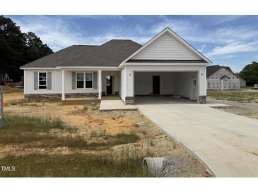 New construction featuring a two-car garage, stone accents, and a covered porch at 71 Royal Ave, Selma, NC 27576