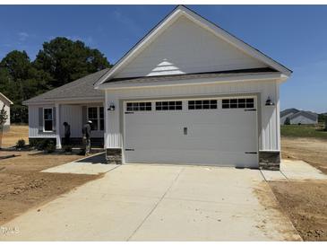 Charming home with a large two-car garage and bright white trim at 71 Royal Ave, Selma, NC 27576
