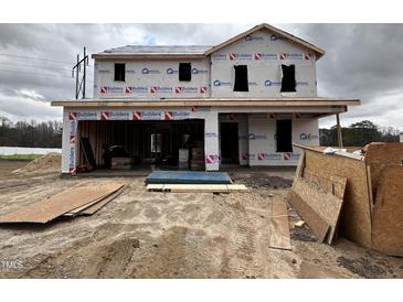 Unfinished construction of a two-story home showing lumber and building materials with overcast skies at 82 W Emily Gardens Dr, Selma, NC 27577