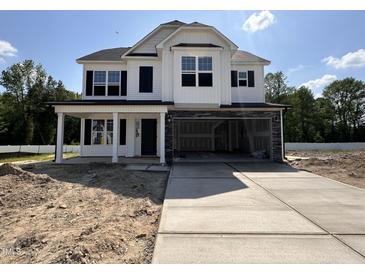 New two-story home with a spacious two-car garage and concrete driveway at 83 W Emily Gardens Dr, Selma, NC 27576