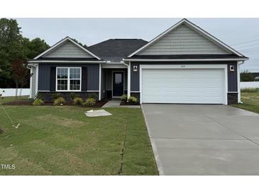 Charming single-story home featuring a two-car garage, well-manicured lawn, and appealing curb appeal at 89 W Emily Gardens Dr, Selma, NC 27576