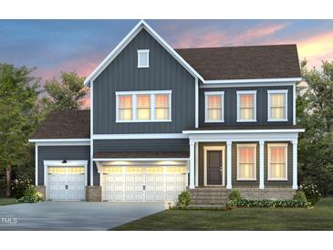 Charming two-story home with a three-car garage and gray siding in a beautiful suburban setting at 102 E Star Foal Ln, Wendell, NC 27591