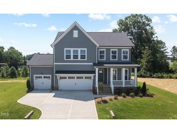 Beautiful gray two-story home featuring a two-car garage and a charming front porch at 102 E Star Foal Ln, Wendell, NC 27591