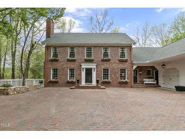 Charming brick home with classic architecture and beautiful flower boxes under the windows at 2004 Riverview Dr, Clayton, NC 27527