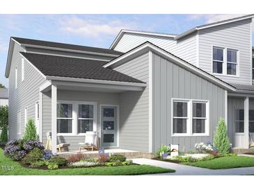 Charming home featuring a welcoming front porch, neutral siding, white trim and a beautifully landscaped front yard at 817 Central Pk Dr, Raleigh, NC 27604