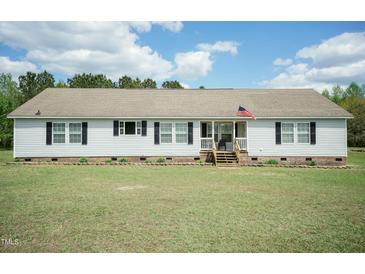 Charming ranch-style home with vinyl siding, black shutters, manicured lawn, and a welcoming front porch at 660 Our Way, Linden, NC 28356