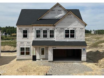New two-story home featuring an attached two-car garage and unfinished yard at 709 Compeer Way # 32, Rolesville, NC 27571