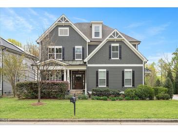 Charming two-story home with gray siding, black shutters, a manicured lawn, and mature landscaping at 800 Laurel Garden Way, Cary, NC 27513