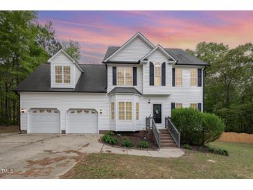 Charming two-story home featuring a manicured lawn, a bay window, and a two-car garage at 9332 Carley Cir, Garner, NC 27529