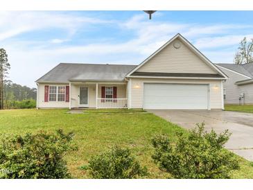 Charming single-story home with a manicured lawn, two-car garage, and inviting curb appeal at 1054 Weathervane Hill Dr, Rocky Mount, NC 27803