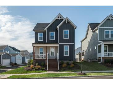 Charming two-story home featuring a cozy front porch and modern exterior paint at 109 Broadwater Dr, Wake Forest, NC 27587