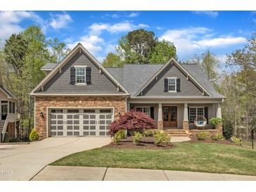 Charming home boasts stone accents, a well-manicured lawn, and a cozy front porch, enhancing its curb appeal at 116 Palermo Ct, Apex, NC 27539