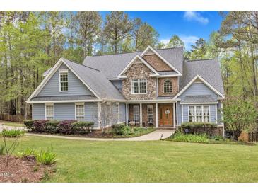 Charming two-story home with a stone and siding facade, landscaped yard, and walkway at 250 Highview Dr, Youngsville, NC 27596