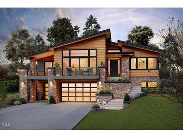 Striking home featuring a modern design, warm wood accents, stone details and a welcoming two-car garage at 2637 Buckeye Ct, Wake Forest, NC 27587