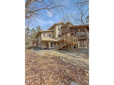 Beautiful multi-level home with wood exterior, multiple decks, and screened-in porch at 2811 Chicken Bridge Rd, Pittsboro, NC 27312