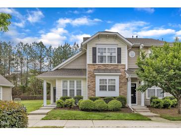 Charming townhome with stone accents, manicured landscaping, and inviting entrance under a blue sky at 345 Red Elm Dr, Durham, NC 27713