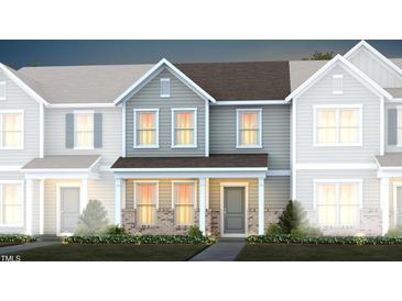 Charming townhome featuring hardiplank siding, a covered entryway and professional landscaping at 351 Fosterton Cottage Way, Raleigh, NC 27603