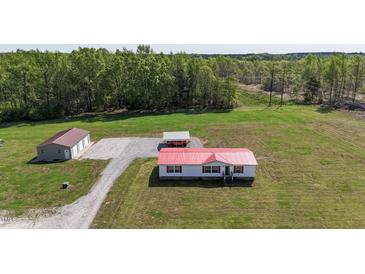 Spacious property featuring a cozy home, a garage, and a carport on a large green lot at 8091 Stone Heritage Rd, Middlesex, NC 27557