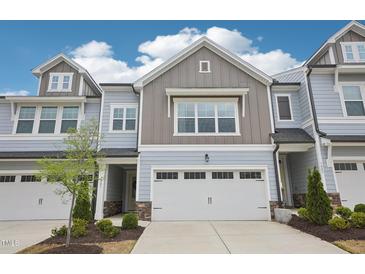Beautiful townhome featuring a two-car garage and tasteful exterior color scheme at 1003 Canary Pepper Dr, Durham, NC 27713