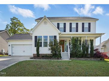 Charming two-story home with white siding, black shutters, and a well-manicured front lawn at 1039 S Philwood Ct, Fuquay Varina, NC 27526