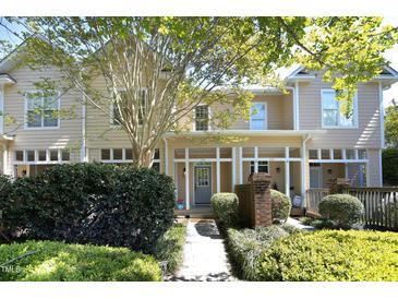 Charming townhouse exterior featuring well-manicured landscaping and a welcoming front porch at 233 Sweet Bay Pl, Carrboro, NC 27510