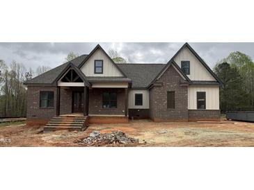 Charming new construction featuring brick, vertical siding, and a welcoming front porch at 3920 Cedar Knolls Drive Dr # 18, Youngsville, NC 27596