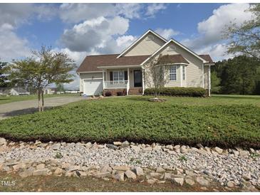 Charming one-story home with a well-manicured lawn and inviting front porch, perfect for relaxation at 46 Grain Ln, Henderson, NC 27537