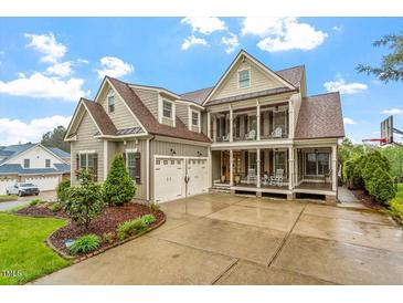 Stunning two-story home featuring a welcoming front porch and manicured landscaping, creating inviting curb appeal at 528 Clifton Blue St, Wake Forest, NC 27587
