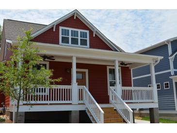 Charming red two-story home with a covered front porch and white railings at 608 Hemlock Ave, Durham, NC 27707