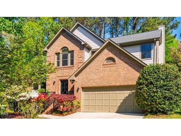 Charming brick home with a two-car garage and mature landscaping at 103 Windhover Dr, Chapel Hill, NC 27514