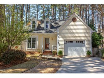 Charming home featuring dormer windows, attached garage, and a manicured lawn at 111 Fox View Pl, Cary, NC 27511