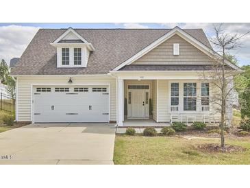 Charming home with a two-car garage, covered porch, and manicured lawn at 1112 Addington Lake Ln, Knightdale, NC 27545