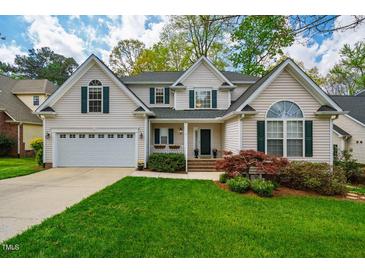 Beautiful two-story home with manicured lawn, attached garage, and decorative shutters at 113 Glenmore Rd, Chapel Hill, NC 27516