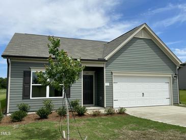 Charming one-story home featuring a two-car garage, manicured lawn, and tasteful landscaping at 288 Olivia Crossing Ct # 10, Four Oaks, NC 27524