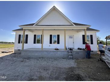 New construction home featuring white siding, black shutters, and a welcoming front porch with exposed pillars at 2895 Bakers Chapel Rd, Smithfield, NC 27577