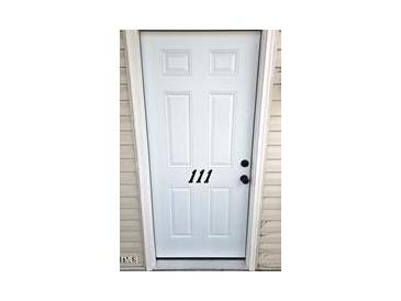 White front door with the number 111 in black numbers centered on the door at 3015 Winston Dr # 111, Burlington, NC 27215