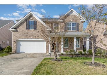 Charming two-story brick home with a two car garage and well-manicured lawn at 360 Callandale Ln, Durham, NC 27703