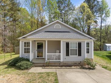 Charming one-story home with a covered front porch and well-maintained landscaping at 420 Feldspar Way, Durham, NC 27703