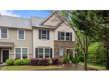 Charming townhome featuring a stone facade and well-maintained landscaping at 4523 Tarkiln Pl, Wake Forest, NC 27587