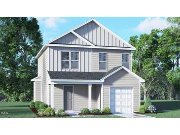 Charming two-story home with gray siding, a covered porch, attached garage and manicured landscaping at 6049 Sodium St, Raleigh, NC 27610