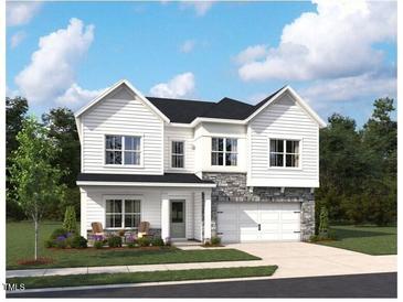 Charming two-story home featuring white siding, stone accents, a two-car garage, and a welcoming front porch at 705 Compeer Way # 31, Rolesville, NC 27571