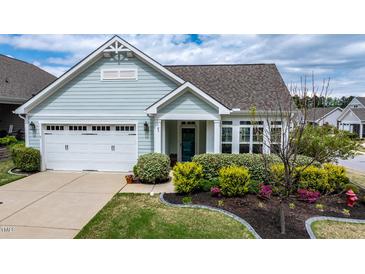 Charming single-story home with a well-manicured lawn and a two-car garage at 85 Bramble Ln, Clayton, NC 27527
