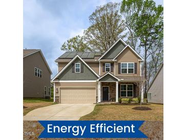 Charming two-story home featuring a well-maintained lawn and solar panels for energy efficiency at 108 Pronghorn Deer Ct, Garner, NC 27529
