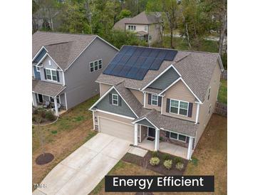 Two-story home boasting solar panels, landscaped yard, and a neutral color palette at 108 Pronghorn Deer Ct, Garner, NC 27529