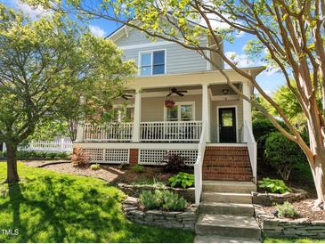 Charming two-story home boasts a welcoming front porch and beautifully landscaped front yard at 119 Weaver Mine Trl, Chapel Hill, NC 27517
