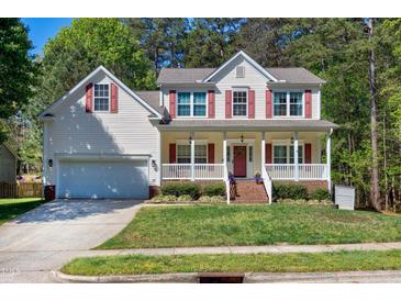 Charming two-story home with a covered front porch, red shutters, and a well-manicured lawn at 1310 Country Club Dr, Durham, NC 27712
